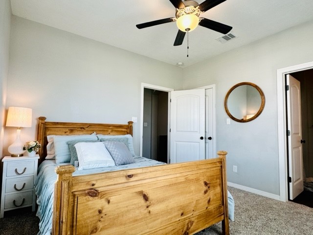6934 Halter Loop College Station, TX 77845 - Photo 14 of 31 a bedroom with a bed and a chandelier