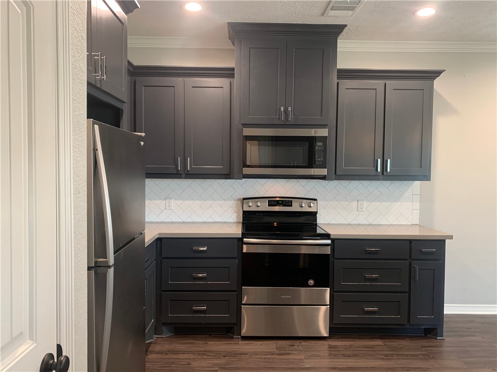 6934 Halter Loop College Station, TX 77845 - Photo 5 of 31 a kitchen with appliances a sink and cabinets