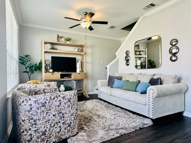 a living room with furniture and a flat screen tv