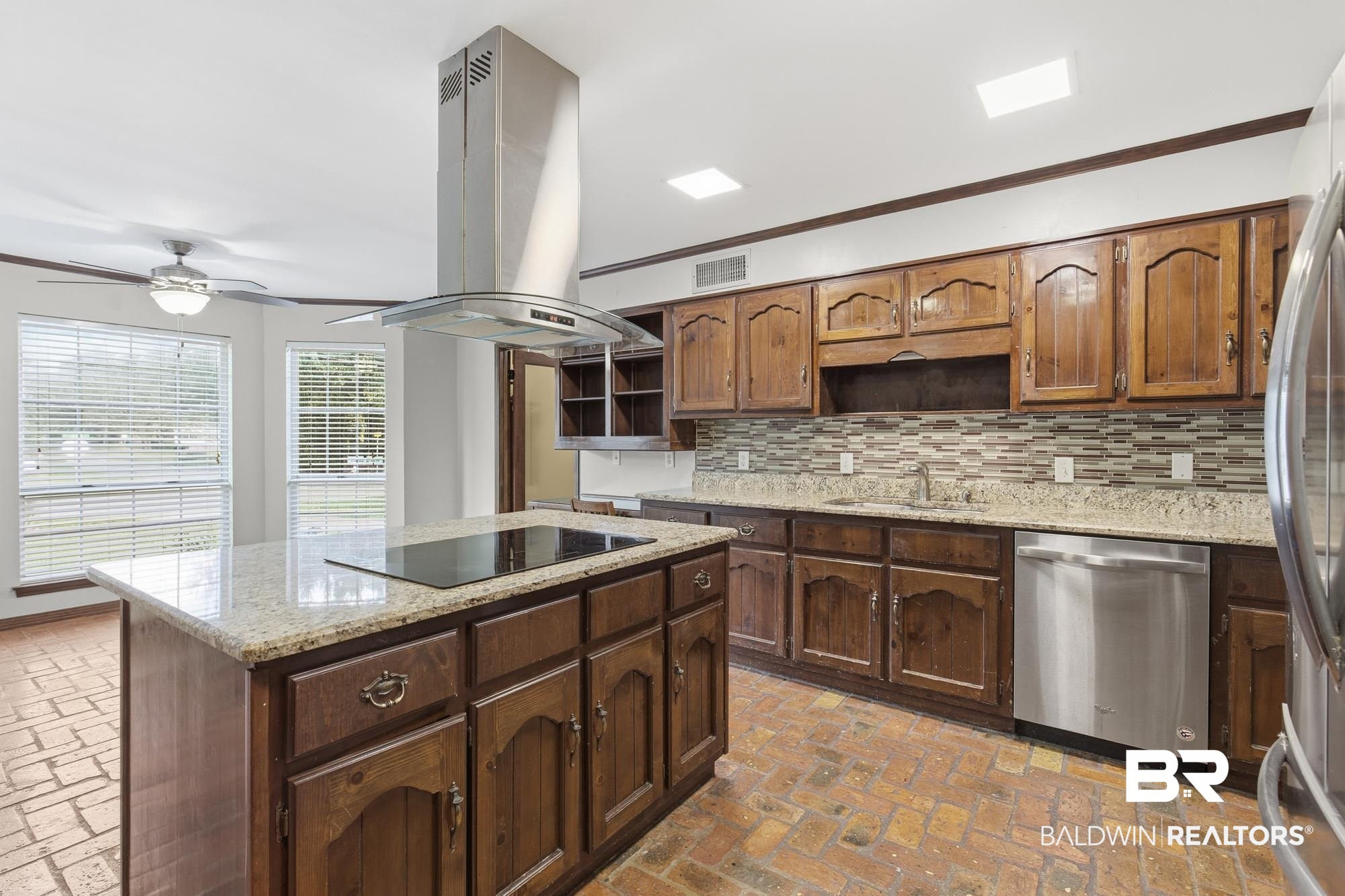 9215 Shiloh Drive Mobile, AL 36695 - Photo 7 of 32 Kitchen with open shelves, ornamental molding, brick flooring, light stone counters, and appliances with stainless steel finishes
