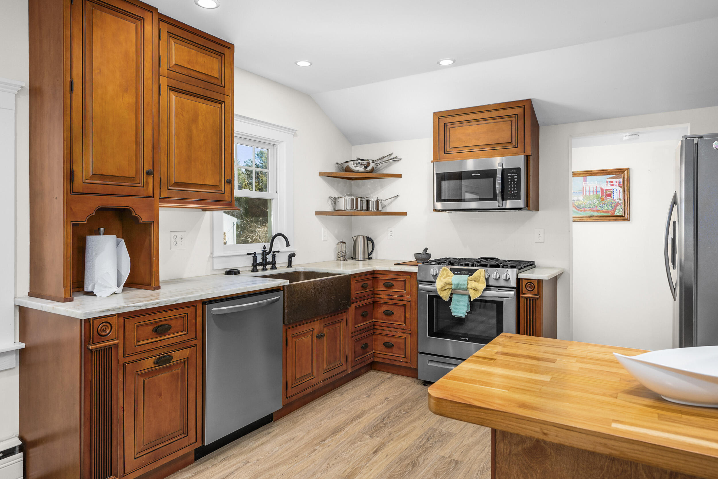 120 Main Street Cotuit, MA 02635 - Photo 11 of 40 a kitchen with stainless steel appliances granite countertop a sink dishwasher stove and refrigerator with wooden floor