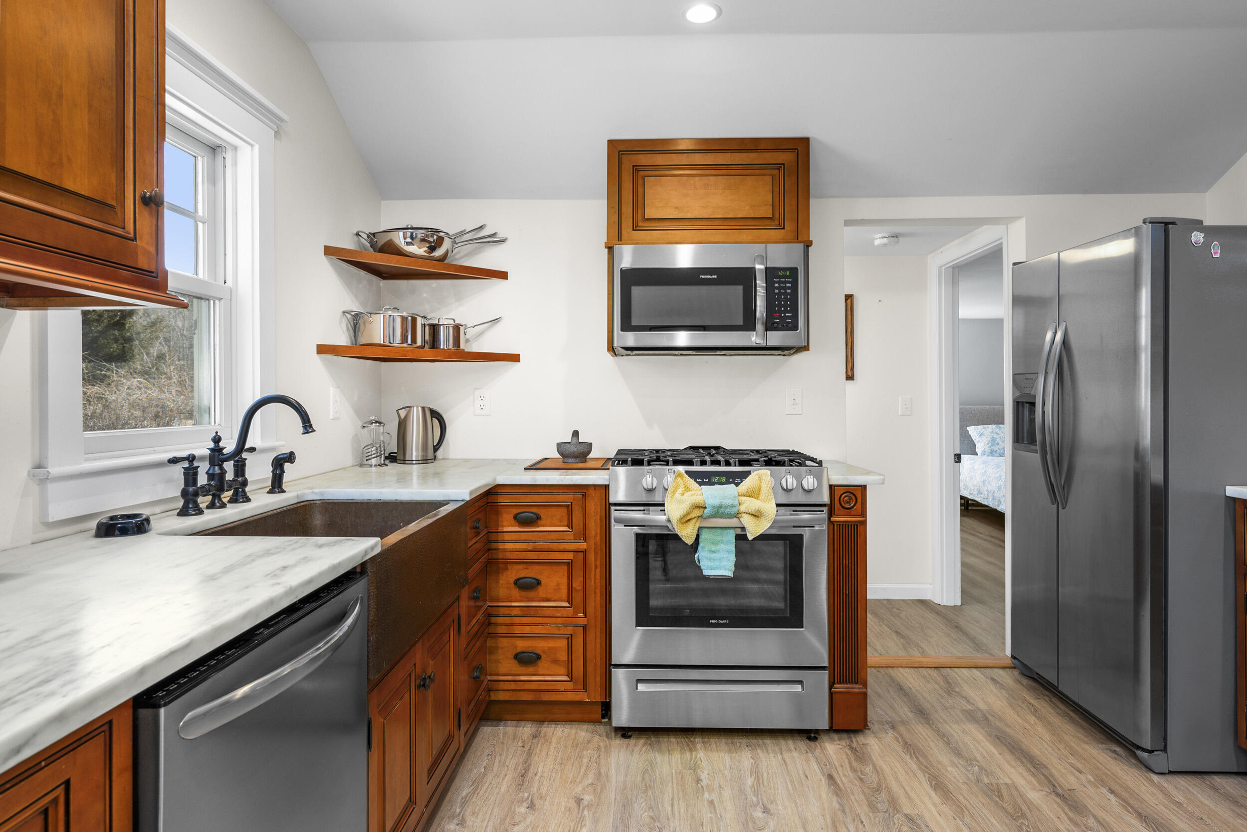 120 Main Street Cotuit, MA 02635 - Photo 12 of 40 a kitchen with stainless steel appliances granite countertop a sink and a stove top oven