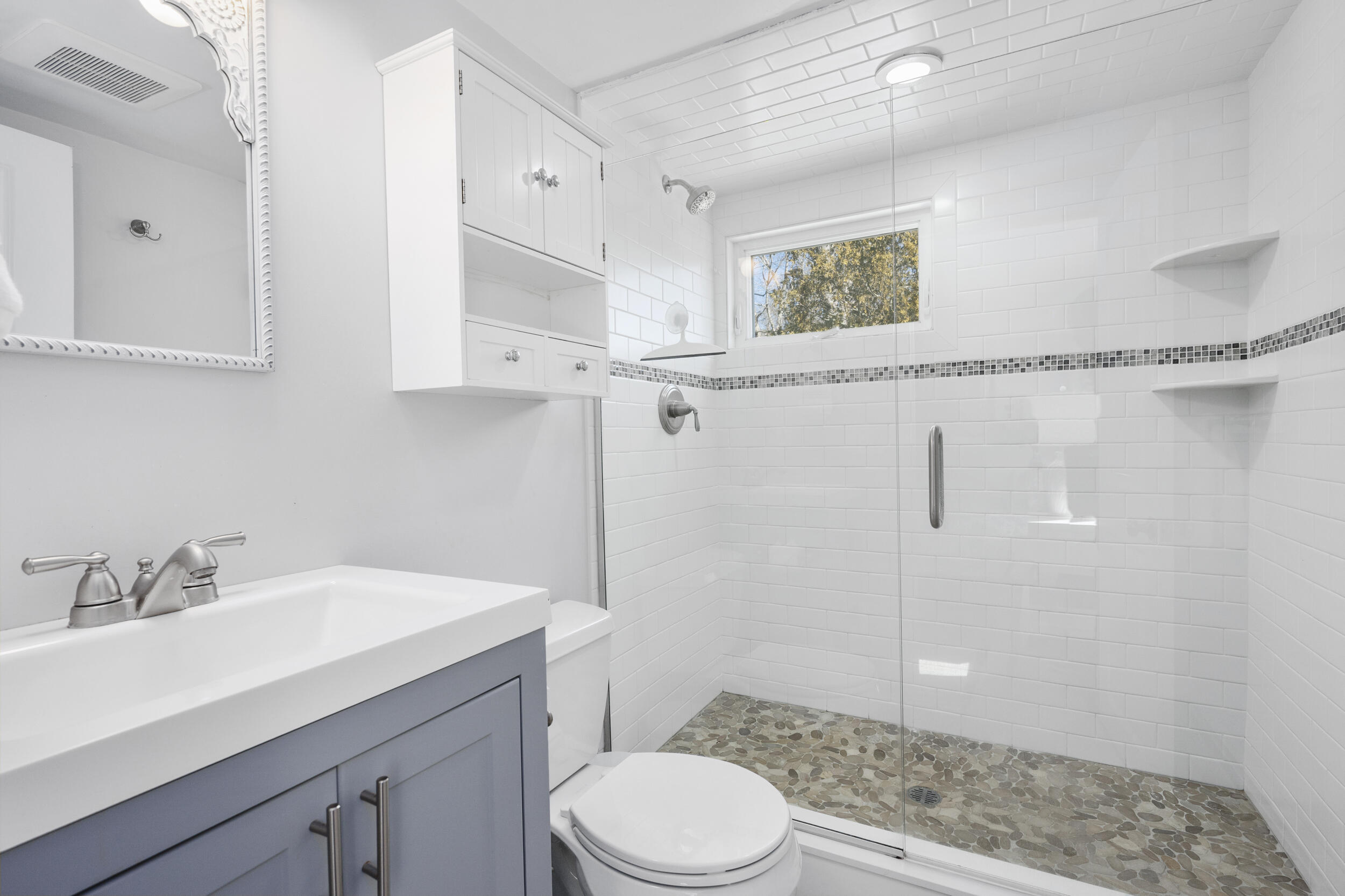 120 Main Street Cotuit, MA 02635 - Photo 17 of 40 a bathroom with a sink a toilet and shower
