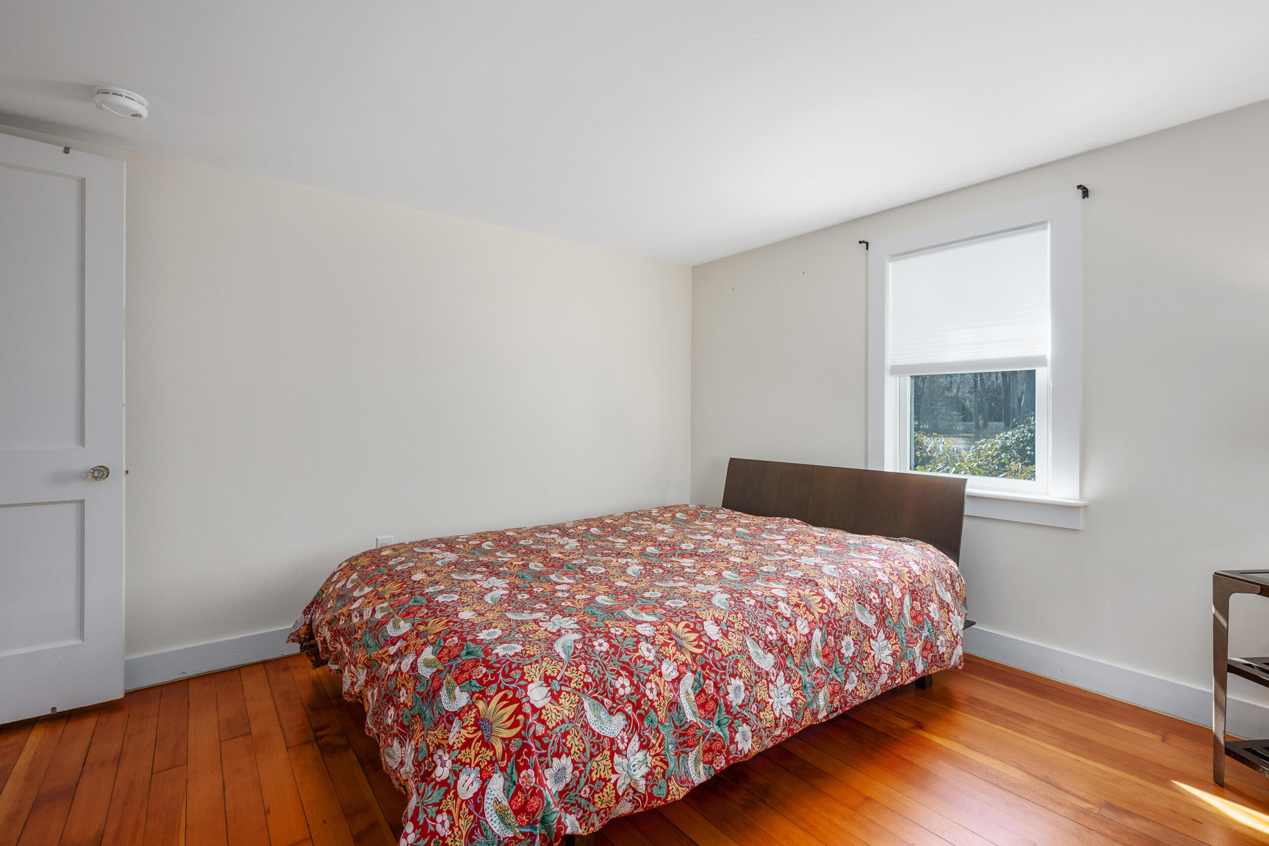 120 Main Street Cotuit, MA 02635 - Photo 19 of 40 a bedroom with a bed and wooden floor