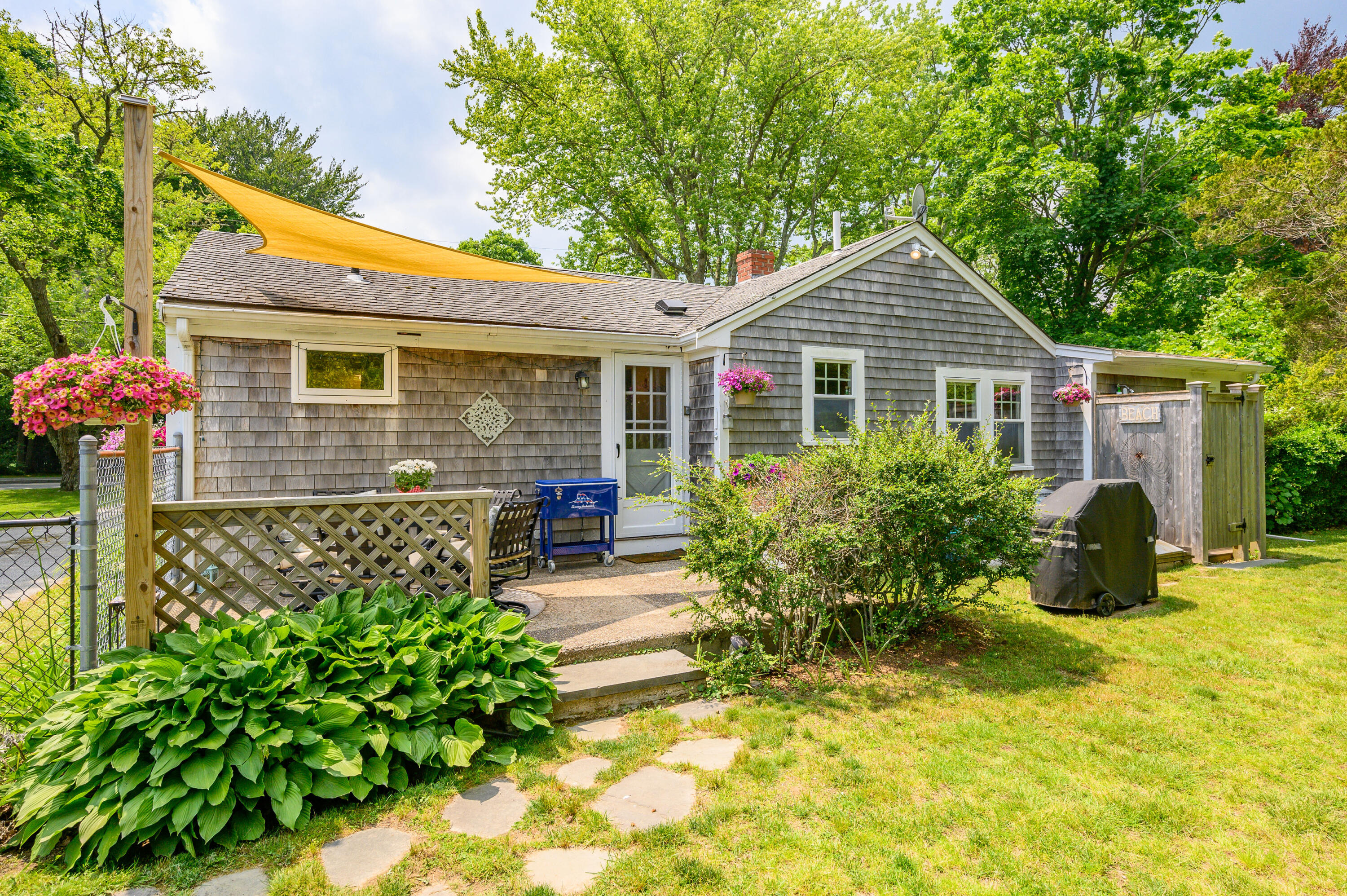 120 Main Street Cotuit, MA 02635 - Photo 2 of 40 a front view of a house with garden
