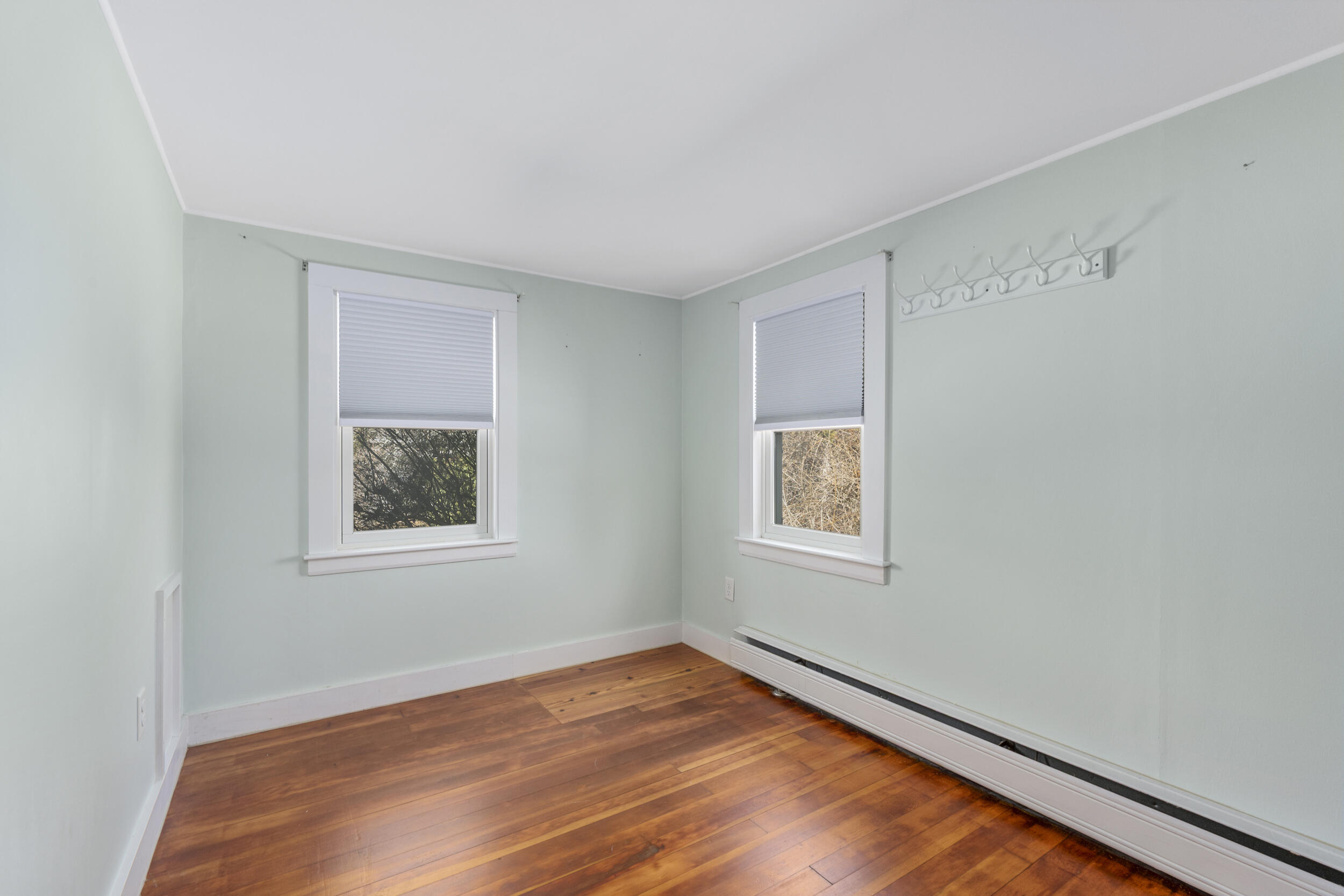 120 Main Street Cotuit, MA 02635 - Photo 21 of 40 an empty room with wooden floor and windows