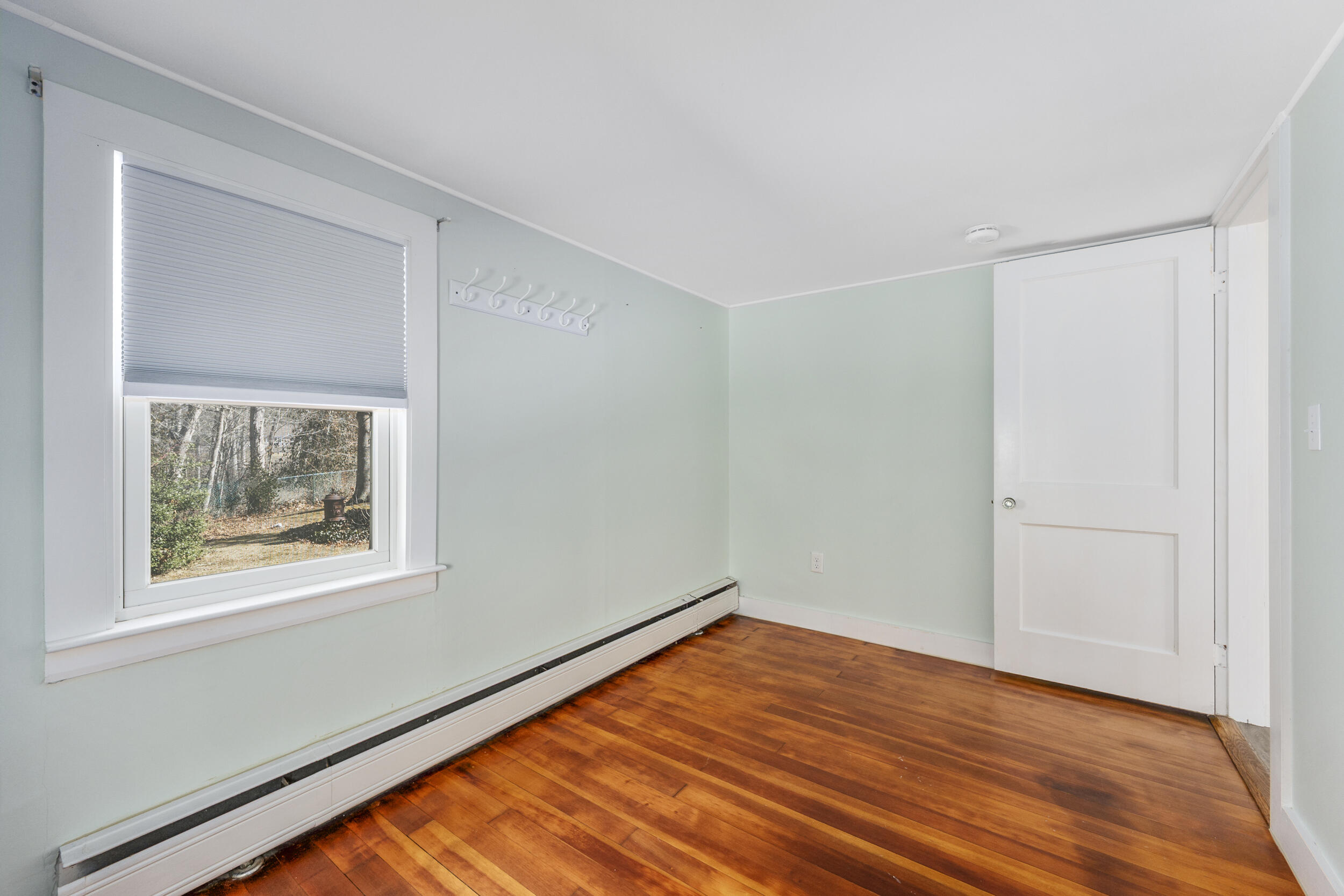 120 Main Street Cotuit, MA 02635 - Photo 22 of 40 a view of empty room with wooden floor and fan