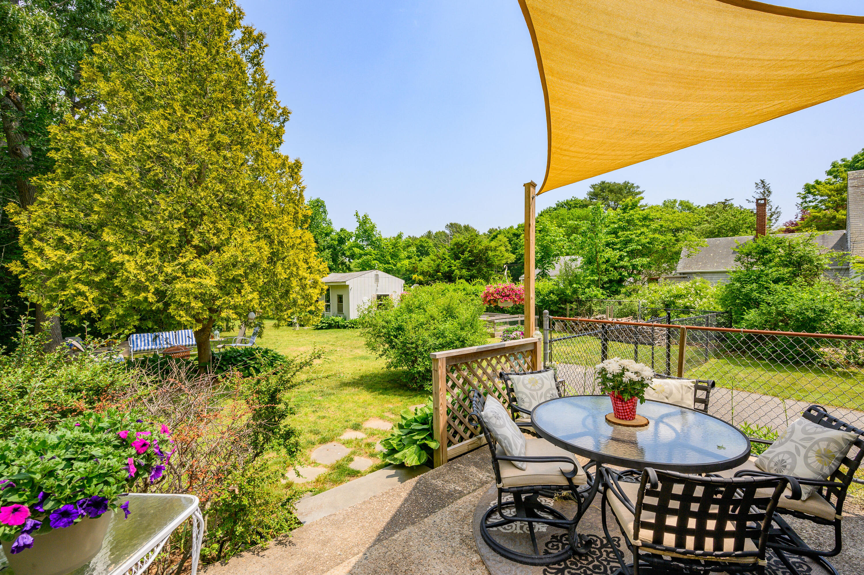 120 Main Street Cotuit, MA 02635 - Photo 33 of 40 a backyard of a house with outdoor seating