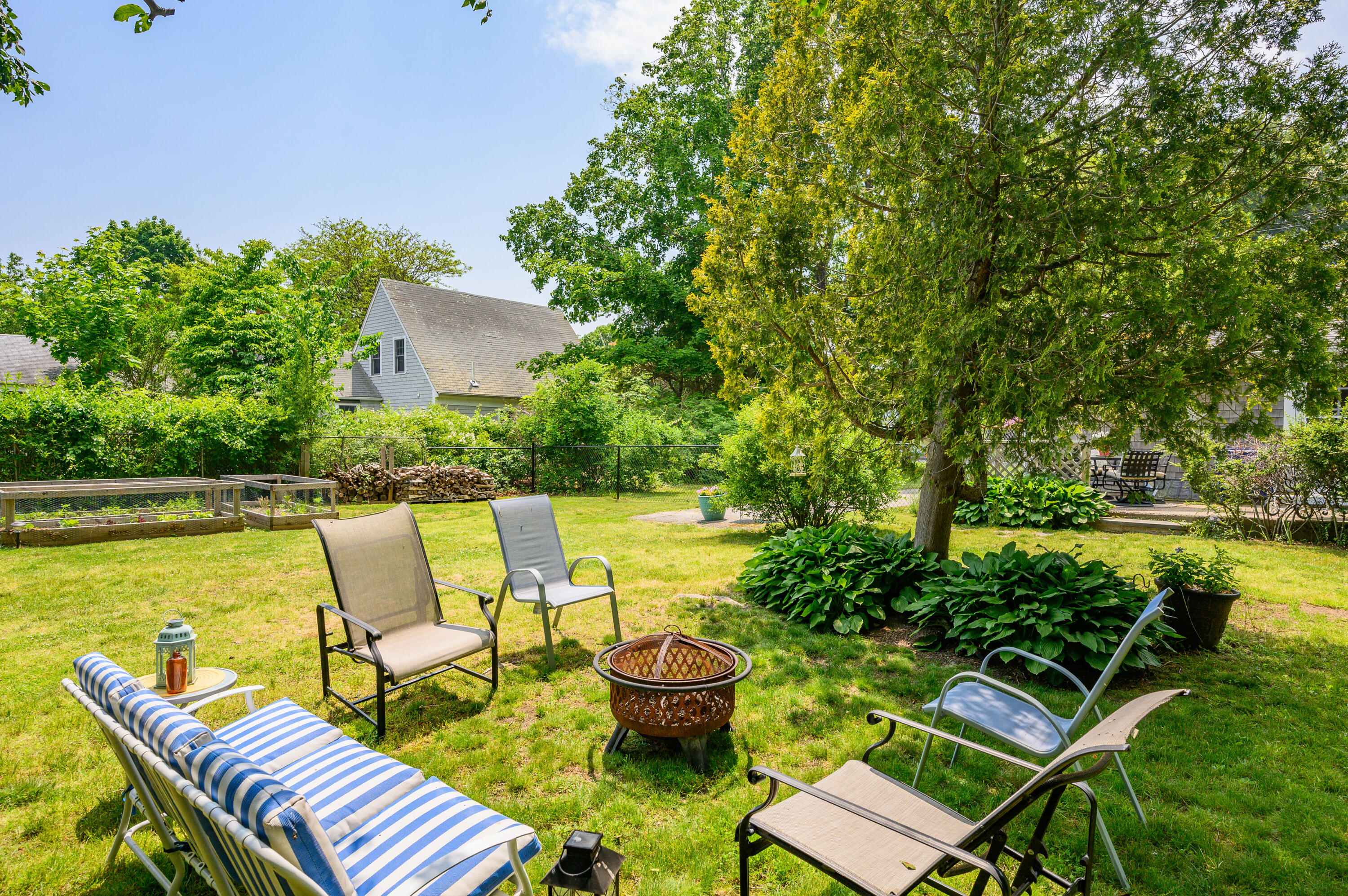 120 Main Street Cotuit, MA 02635 - Photo 34 of 40 a balcony with chairs and a table
