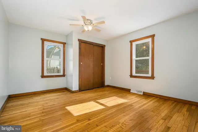 a view of an empty room with wooden floor