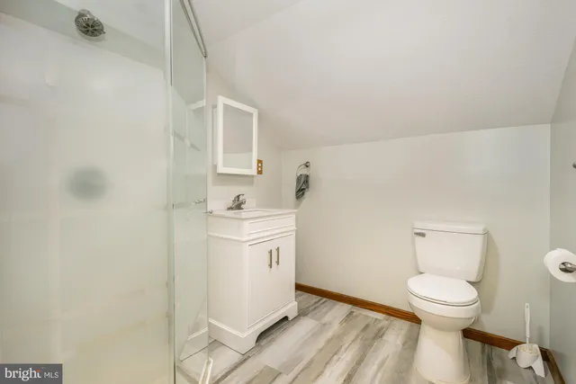 a bathroom with a toilet sink and a mirror
