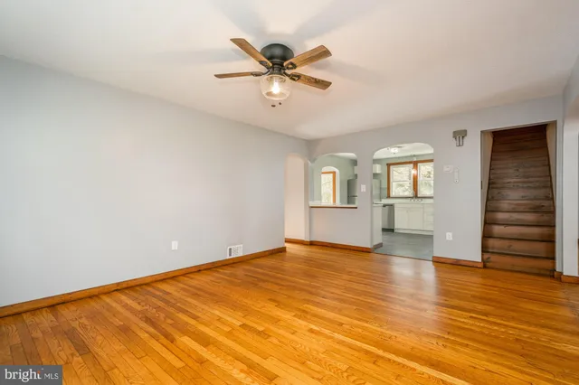 wooden floor in an empty room with a window