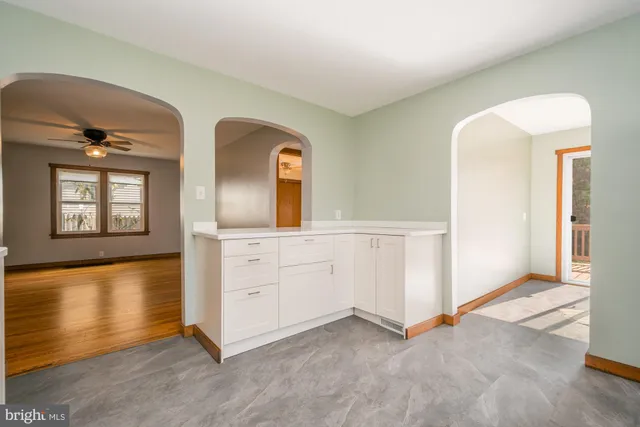 a room with two mirror and a dresser