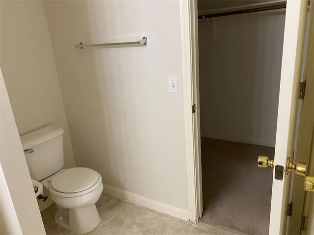 a white toilet sitting next to a shower