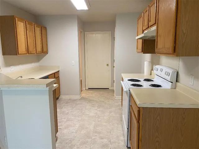 a kitchen with stainless steel appliances granite countertop a sink stove and microwave