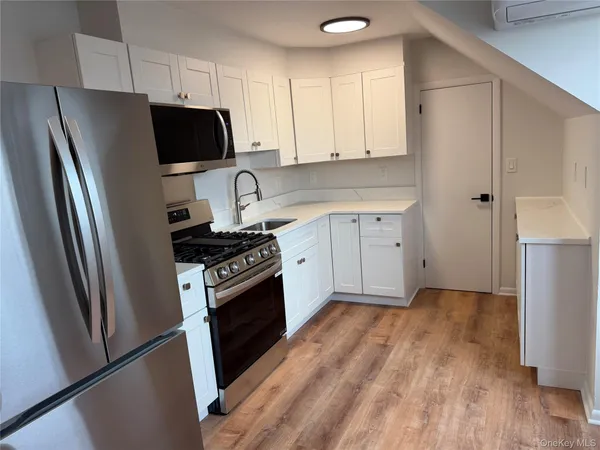 a kitchen with stainless steel appliances a refrigerator stove and sink