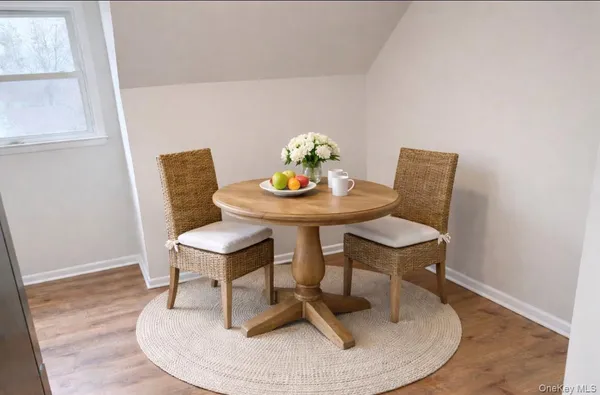 a dining room with furniture and wooden floor