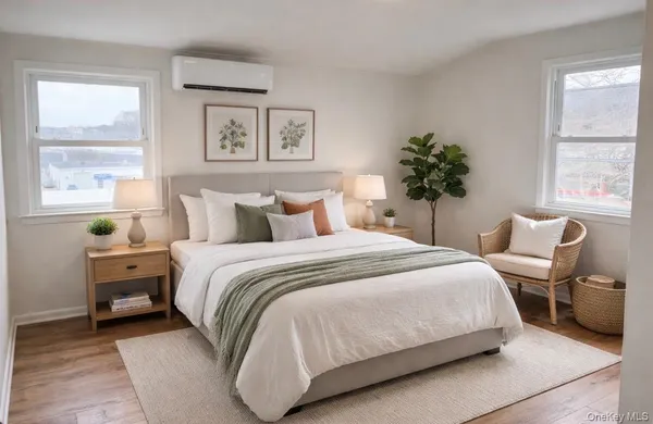 a bedroom with a bed and a large window