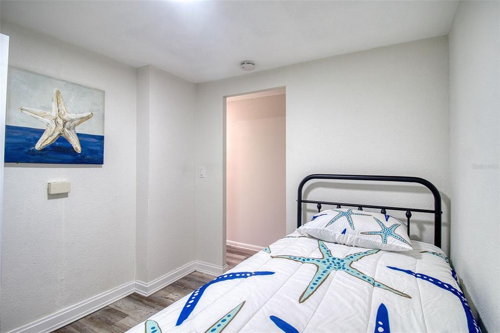 6820 Sea Ranch Drive Hudson, FL 34667 - Photo 13 of 29 a bedroom with a bed and a painting on the wall