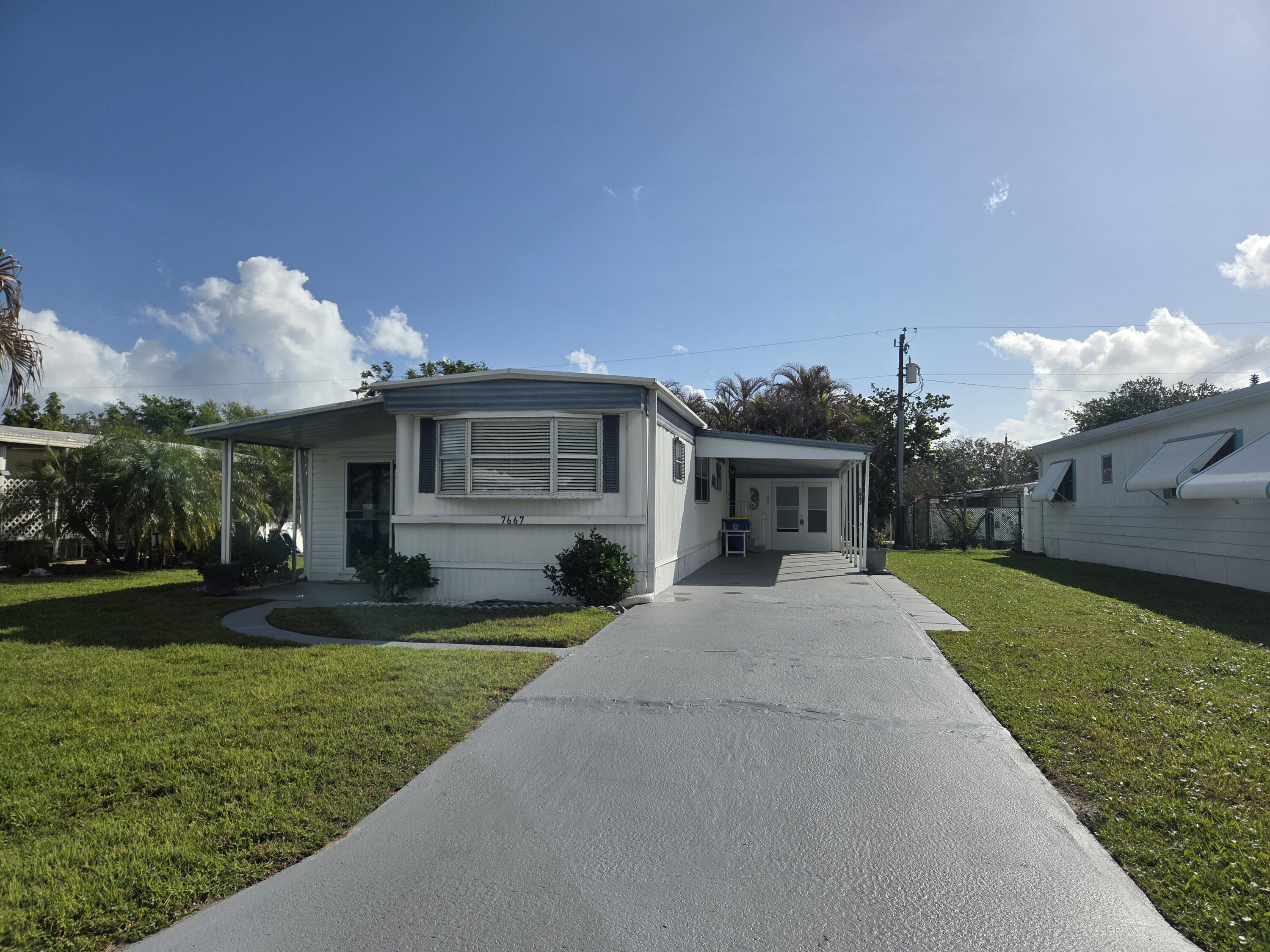 7667 Southeast Swan Avenue Hobe Sound, FL 33455 - Photo 1 of 15 front