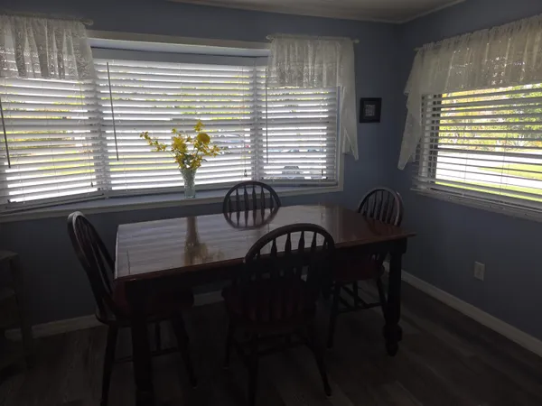 a view of a dining room with furniture and windows