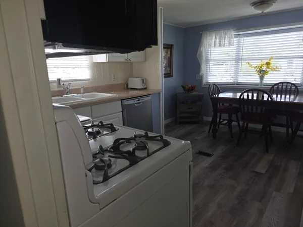 a kitchen with a table chairs and a stove