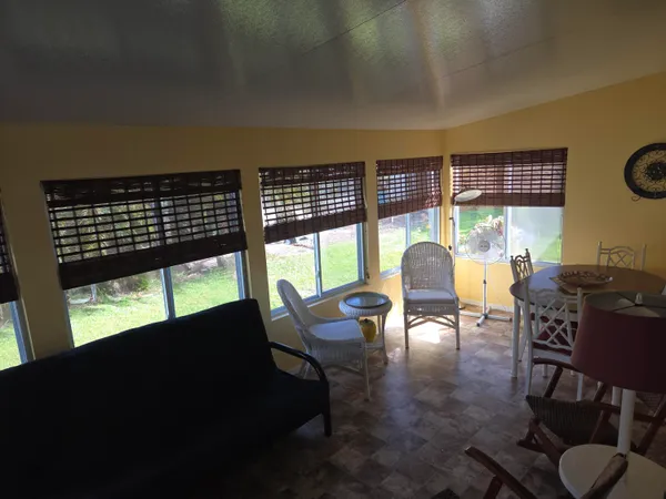 a living room with furniture and a floor to ceiling window