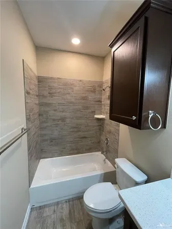 a bathroom with a toilet a sink and bathtub