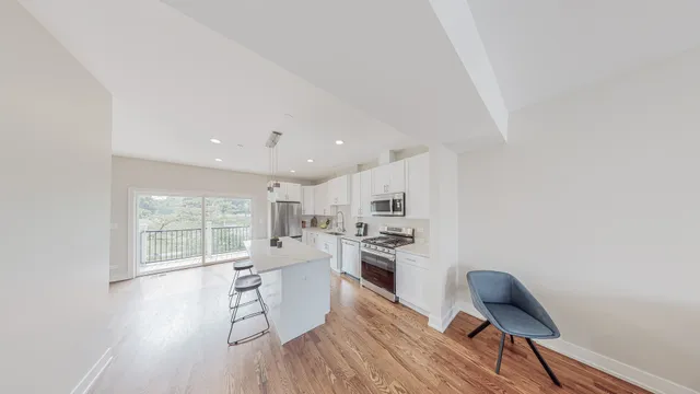 a living room with furniture rug and wooden floor