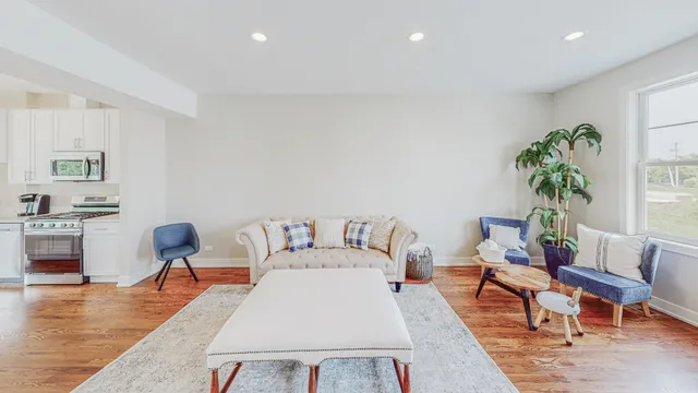 a living room with furniture and wooden floor