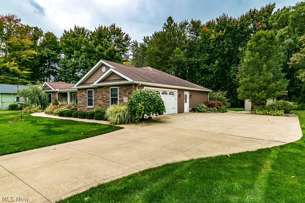 1074 Dock Road Madison, OH 44057 - Photo 2 of 35 Great curb appeal and lush landscaping at this home.
