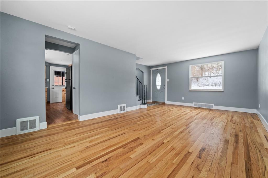 1015 McNeilly Road Pittsburgh, PA 15226 - Photo 2 of 19 a view of empty room with wooden floor and fan