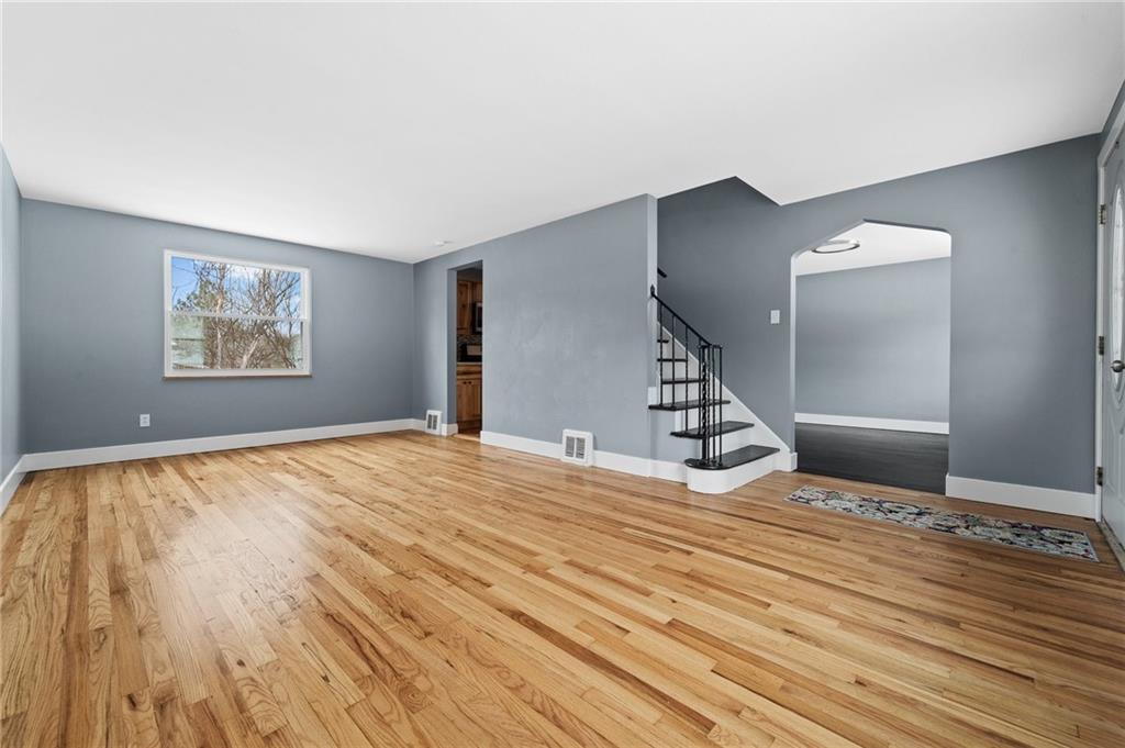 1015 McNeilly Road Pittsburgh, PA 15226 - Photo 3 of 19 a view of an empty room with wooden floor and a window