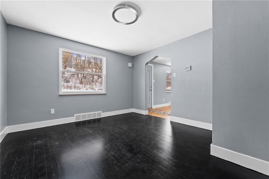 1015 McNeilly Road Pittsburgh, PA 15226 - Photo 5 of 19 an empty room with wooden floor and windows
