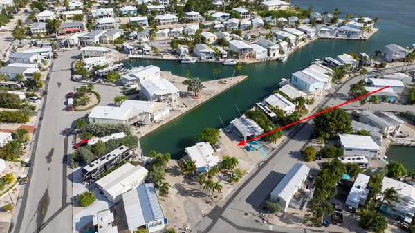 an aerial view of a house yard swimming pool and outdoor seating