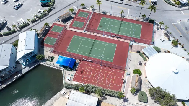 a view of a brick building with many windows and plants