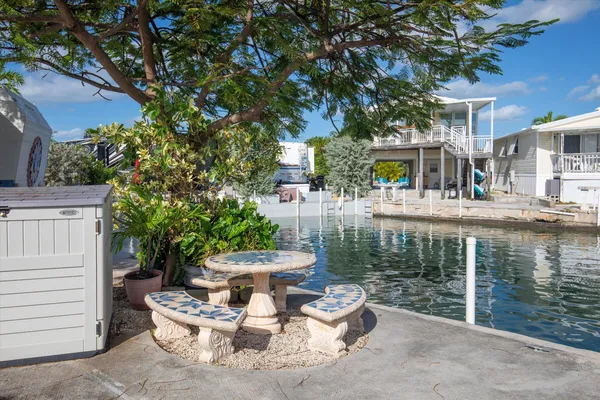 a view of house with backyard outdoor seating and hardwood