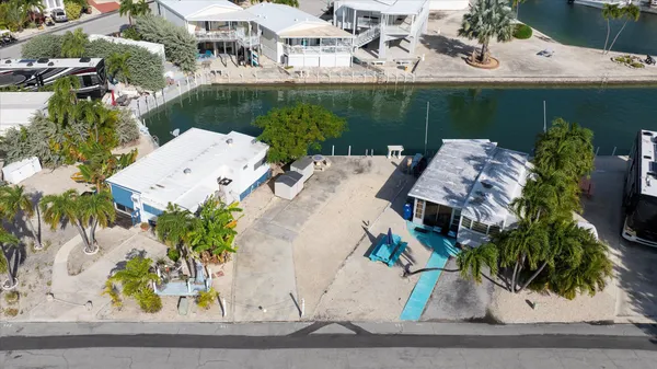 an aerial view of a house with garden space and sitting area
