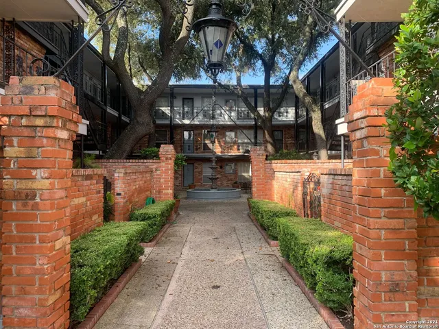 a view of a patio with table and chairs under an umbrella