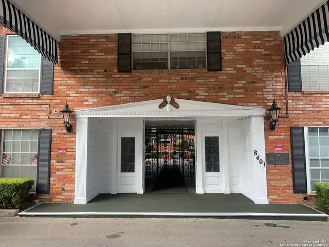 a view of a brick house with entrance gate