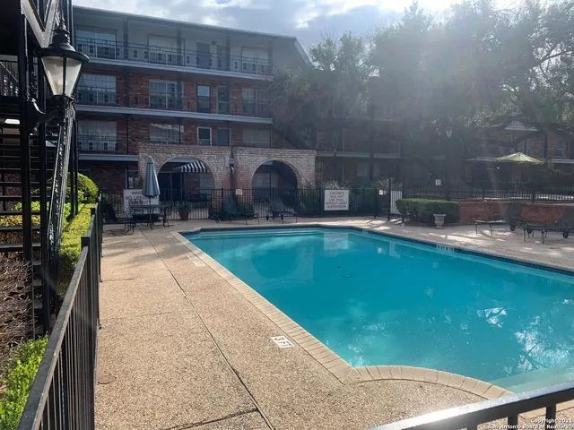 a swimming pool with outdoor seating and yard