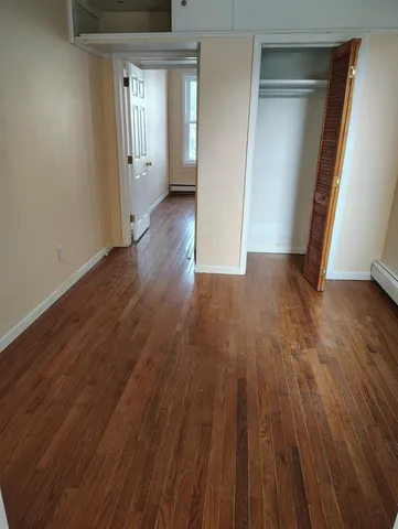 a view of wooden floor and windows in a room