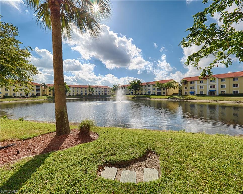 a view of a lake with a yard and trees
