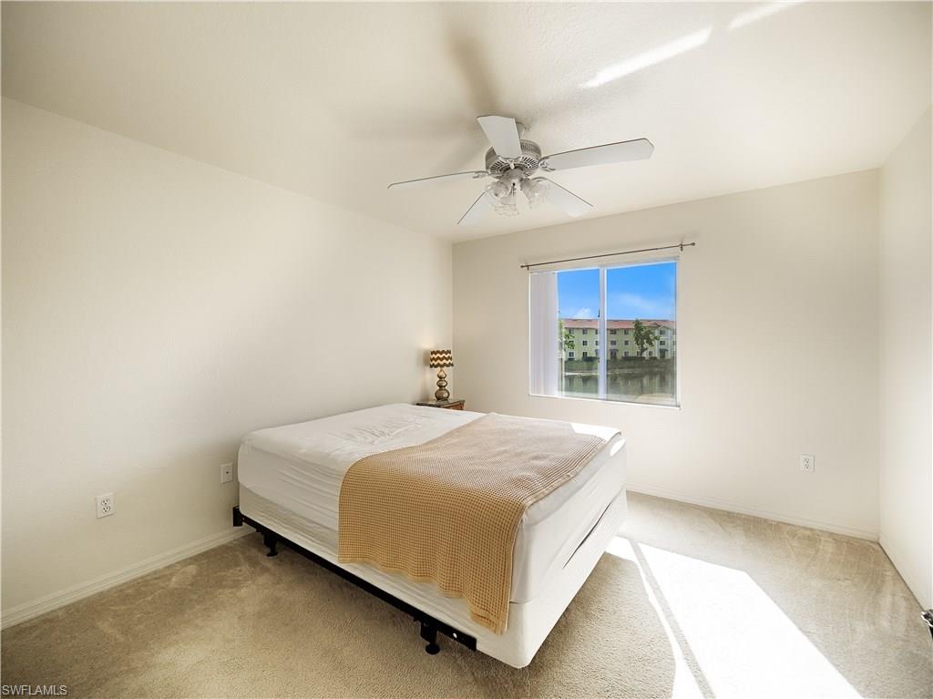 8224 Key Royal Circle, Unit 223 Naples, FL 34119 - Photo 11 of 14 a bedroom with a bed and window