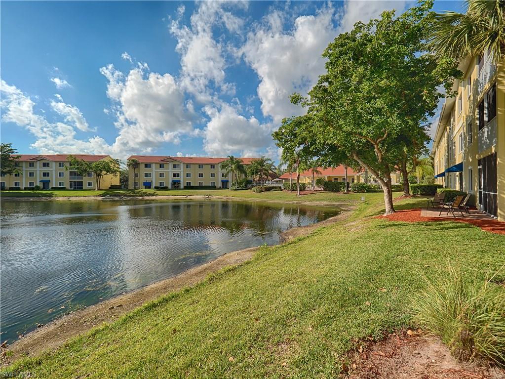8224 Key Royal Circle, Unit 223 Naples, FL 34119 - Photo 14 of 14 a view of a lake with houses