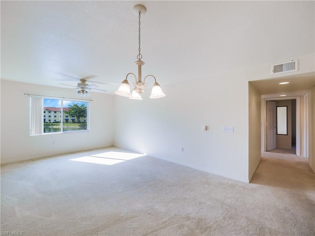 8224 Key Royal Circle, Unit 223 Naples, FL 34119 - Photo 3 of 14 a view of a room with a chandelier