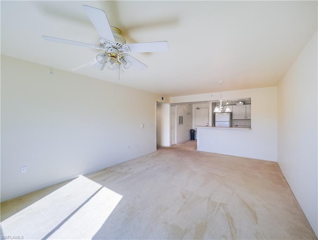 8224 Key Royal Circle, Unit 223 Naples, FL 34119 - Photo 4 of 14 a view of a livingroom with a chandelier fan