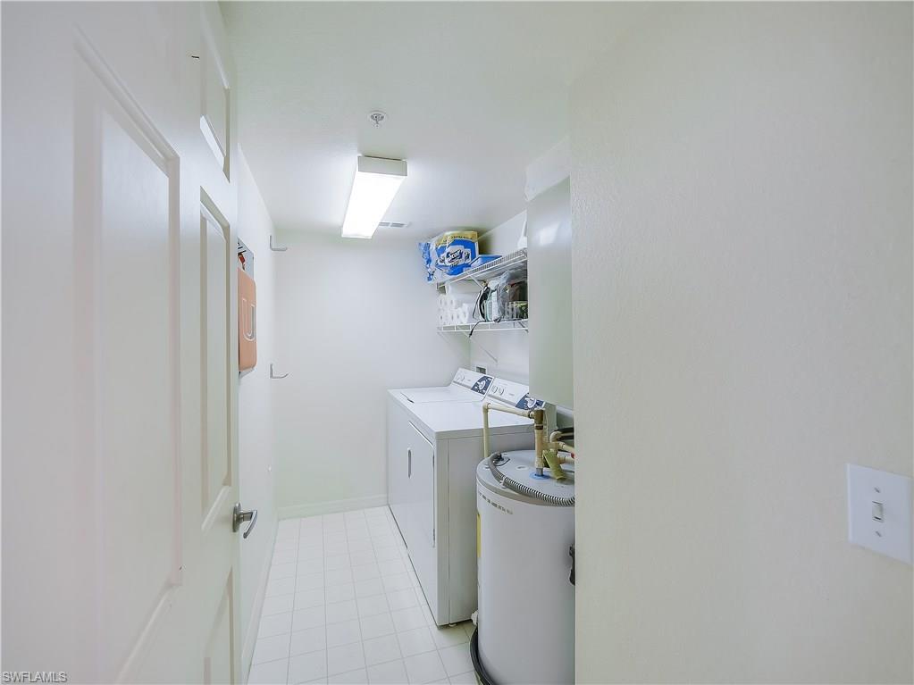8224 Key Royal Circle, Unit 223 Naples, FL 34119 - Photo 9 of 14 a bathroom with a sink a toilet and shower