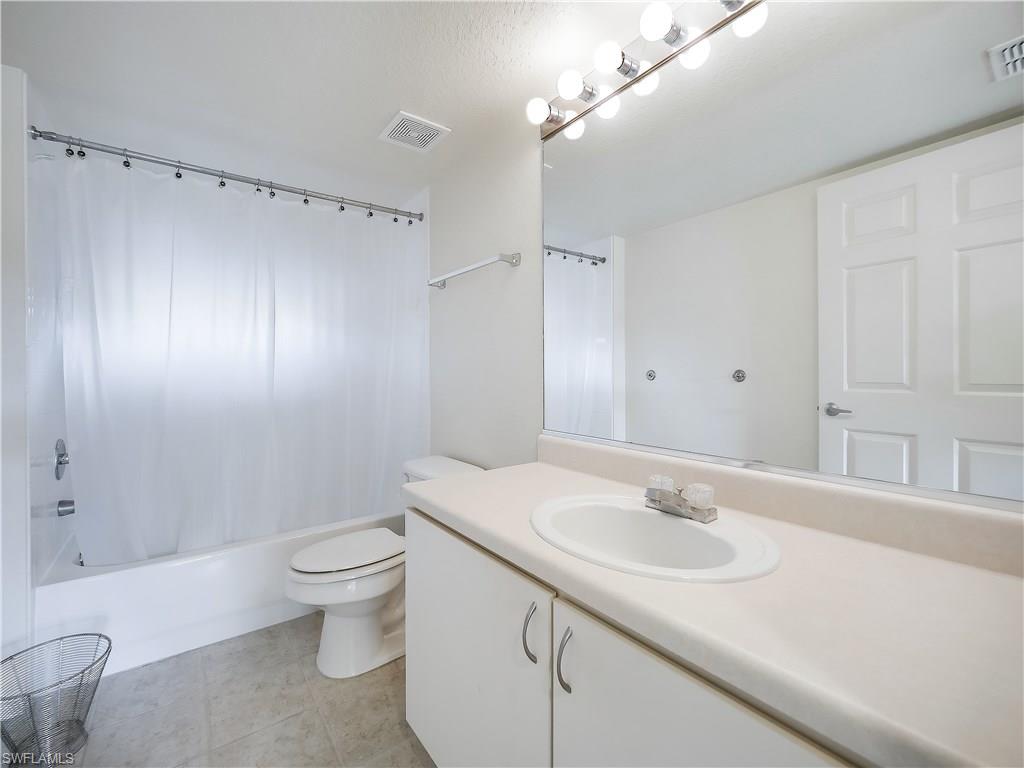 8224 Key Royal Circle, Unit 223 Naples, FL 34119 - Photo 10 of 14 a bathroom with a sink toilet and shower