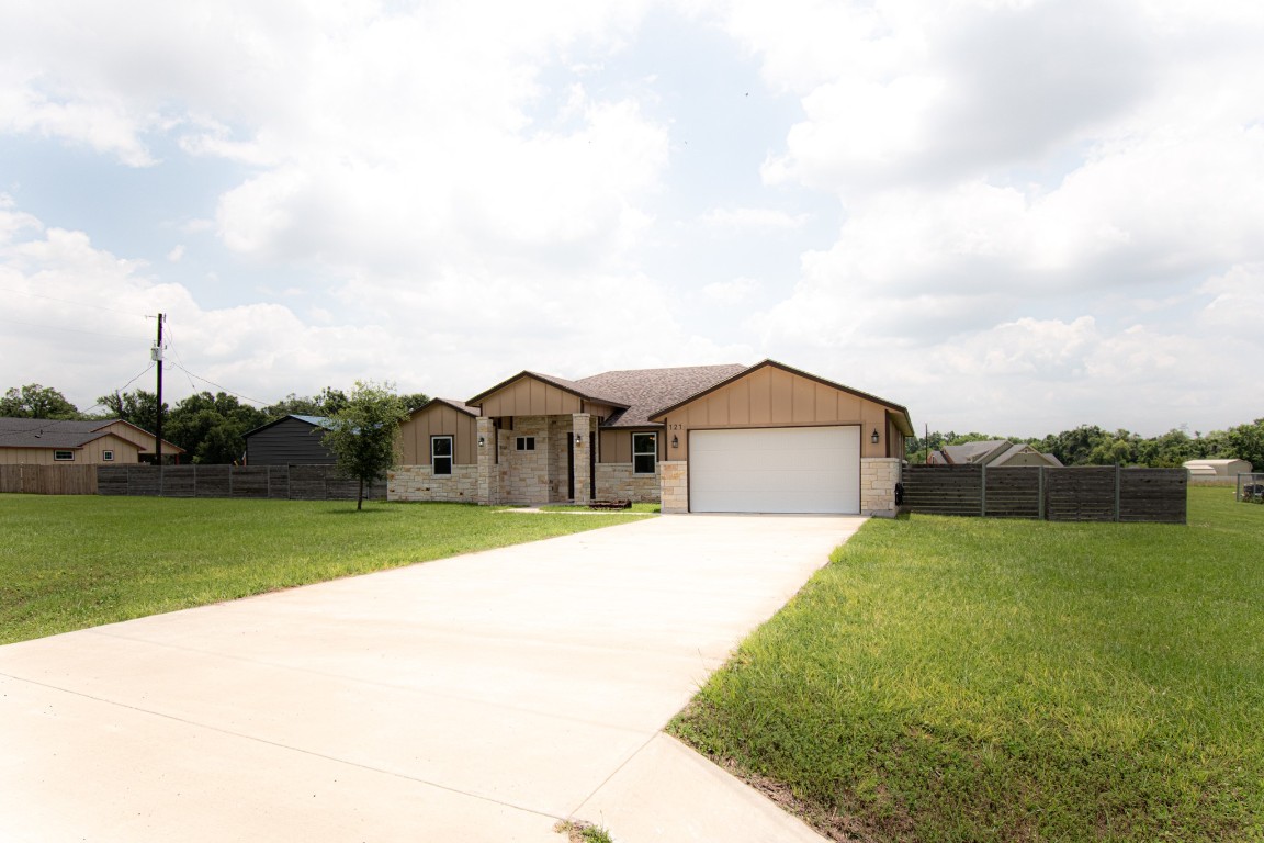 121 Grassy Lane Elgin, TX 78621 - Photo 1 of 1 a house view with a garden space
